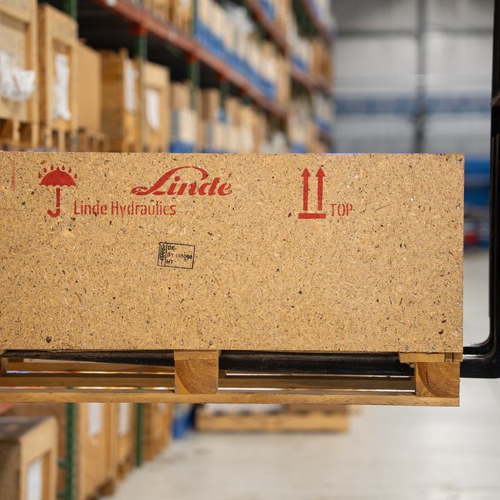 Linde Hydraulics shipping crate on a pallet carried by a forklift in the Lifco warehouse